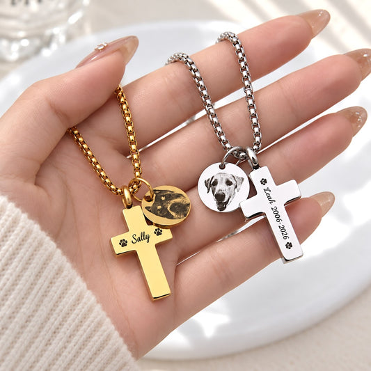 Gold and silver laser-engraved pet memorial cross necklaces displayed in a hand to show pendant size and detail.