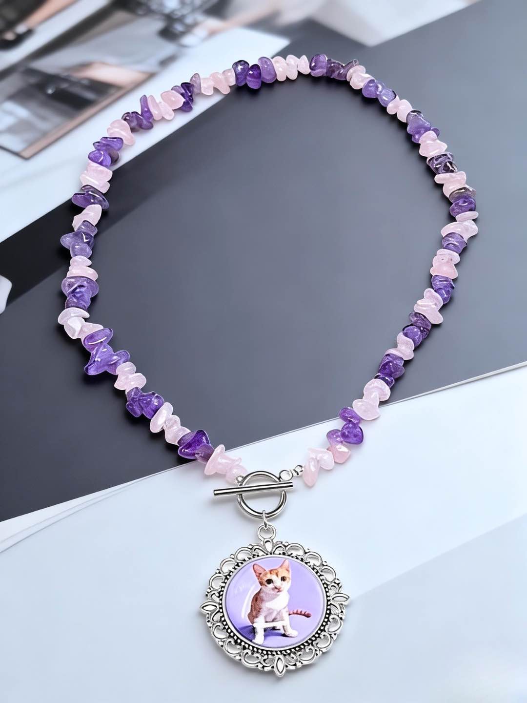 Custom pet photo necklace featuring natural amethyst and rose quartz beads with a vintage silver cat portrait pendant.