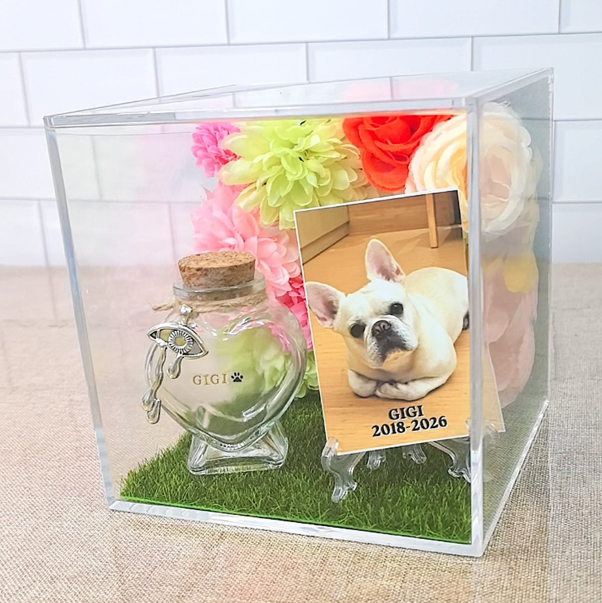 Personalized 3D pet memorial shadow box with custom pet photo, floral decorations, faux grass base, and heart-shaped fur keepsake bottle.