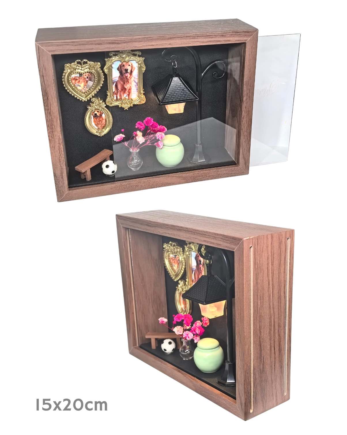 A composite product image of a 15x20cm custom wooden pet memorial shadow box. The top view shows the clear front panel partially sliding open, revealing a 3D diorama with Golden Retriever framed photos, a glowing street lamp, pink flowers, a mini bench, and a green ceramic keepsake jar. The bottom view displays a side angle highlighting the depth and sturdy construction of the wooden frame.